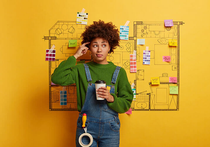 woman holding coffee in front of idea board